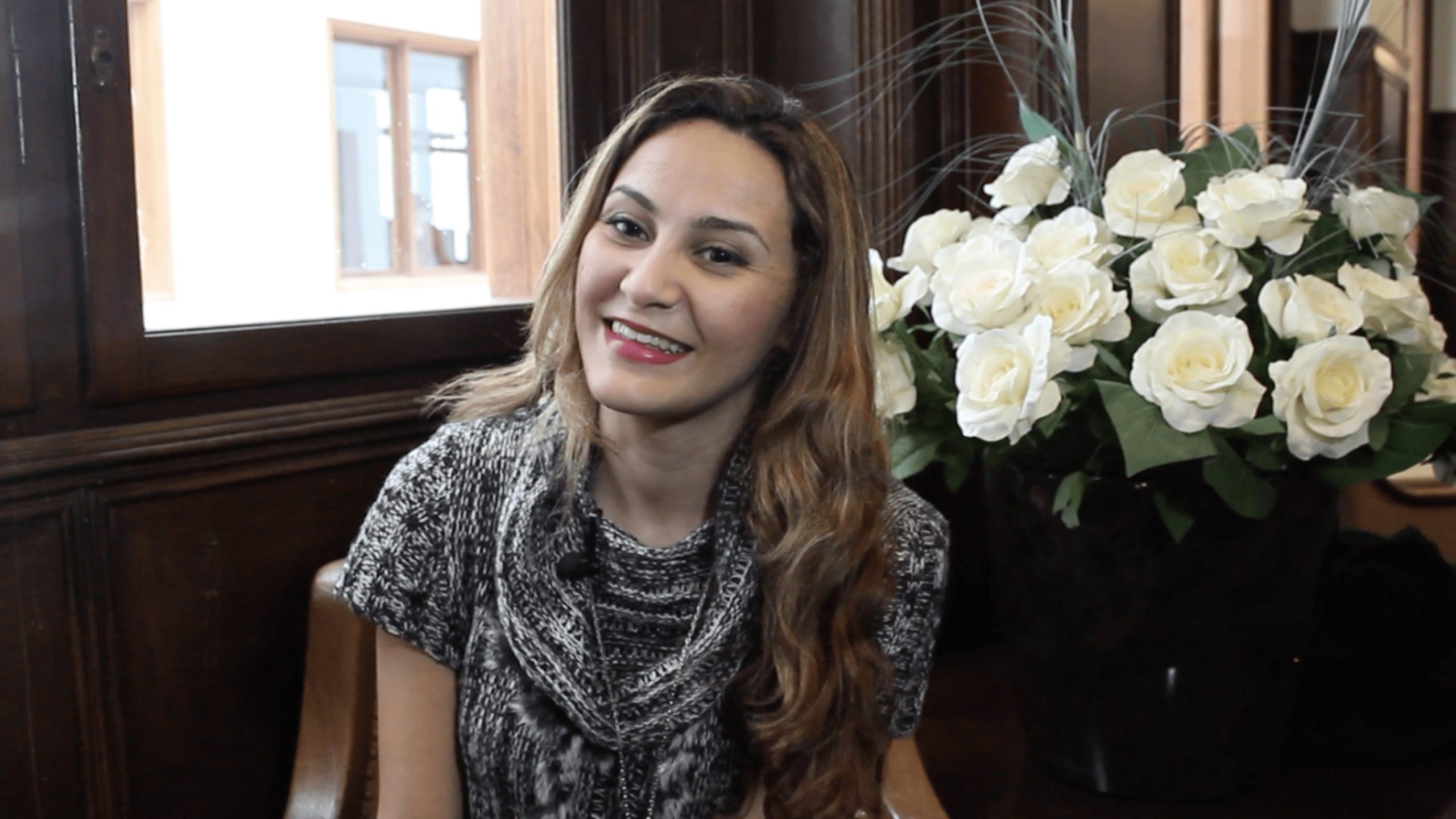 Amel smiles during an interview