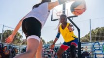 Female basketball players training at city basketball court