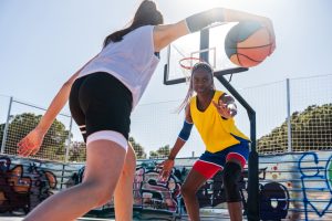 Female basketball players training at city basketball court