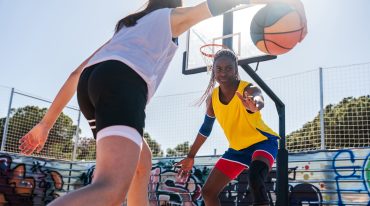 Female basketball players training at city basketball court