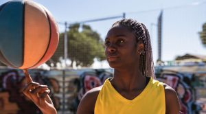 WNBA Black female basketball player training at city court (Photo via Envato Elements)