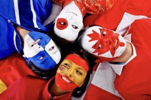 Group of people with flags of different countries (Photo via Envato Elements)