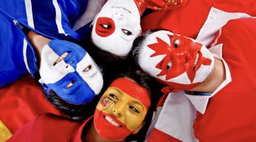 Group of people with flags of different countries (Photo via Envato Elements)