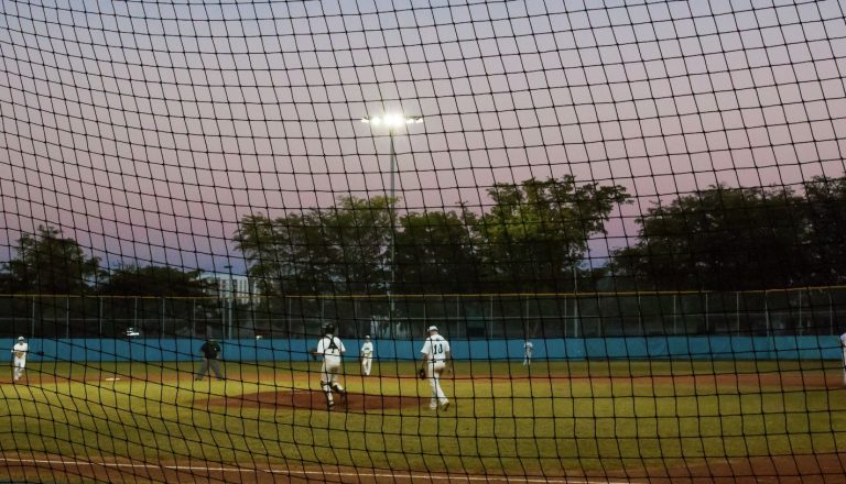 Sunset over high school kids on a baseball field (Photo via Envato Elements)