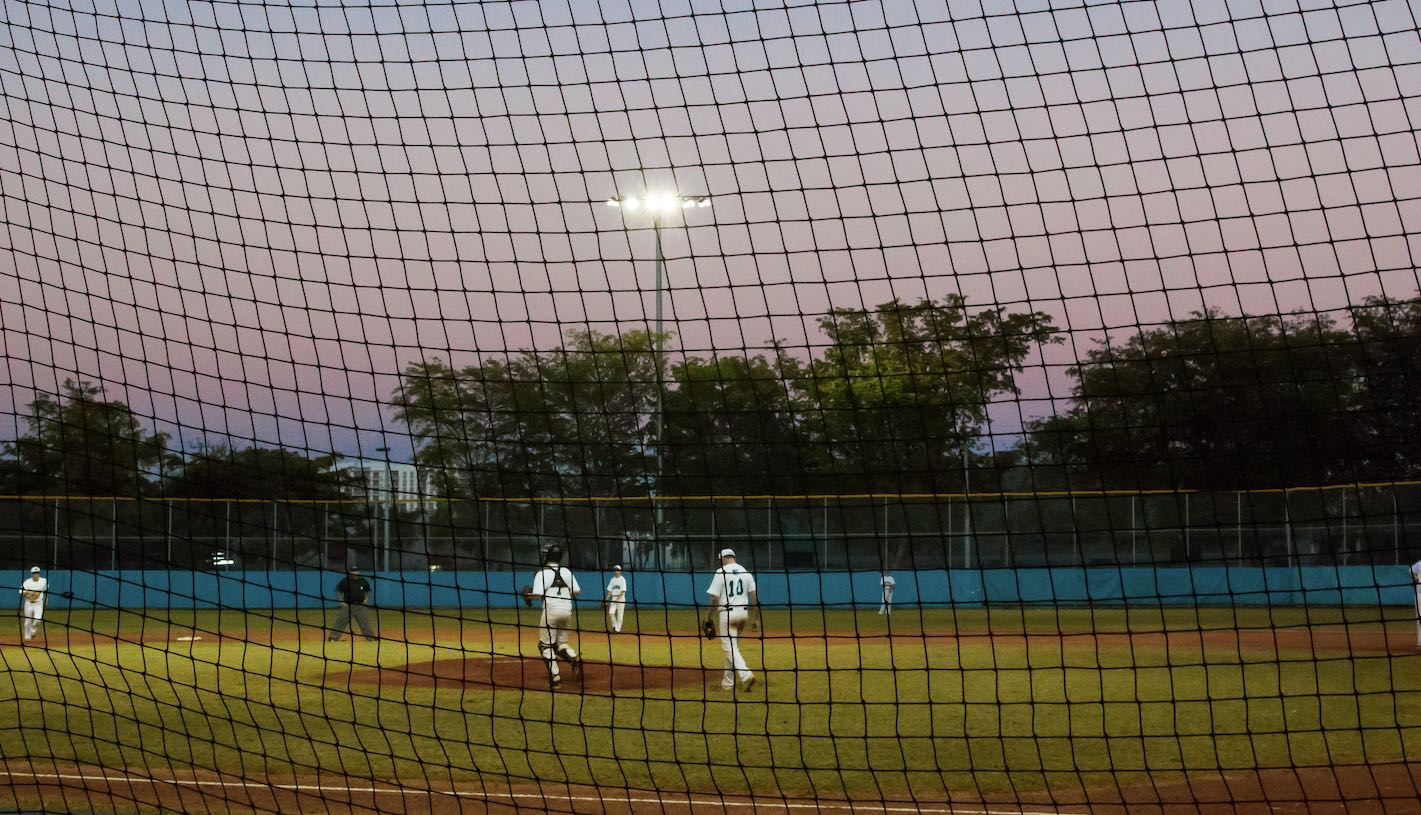 Sunset over high school kids on a baseball field (Photo via Envato Elements)