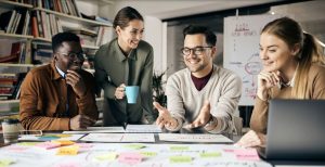 Happy creative marketing team working on new business project in the office. (Photo via Envato Elements)
