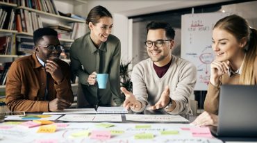 Happy creative marketing team working on new business project in the office. (Photo via Envato Elements)